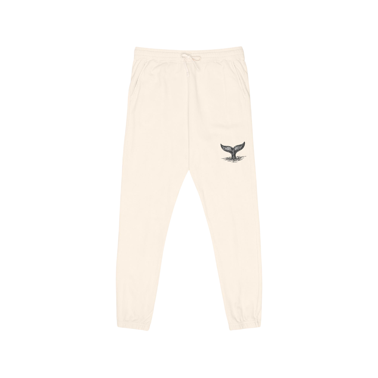 Cream-colored sweatpants with a small black whale tail graphic on the left thigh, featuring an elastic waistband with a drawstring and elastic cuffs.