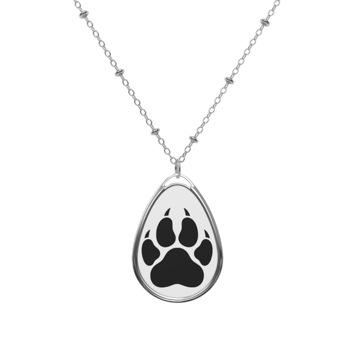A silver teardrop pendant necklace featuring a black paw print design on a white background, suspended from a delicate silver chain with small decorative beads.