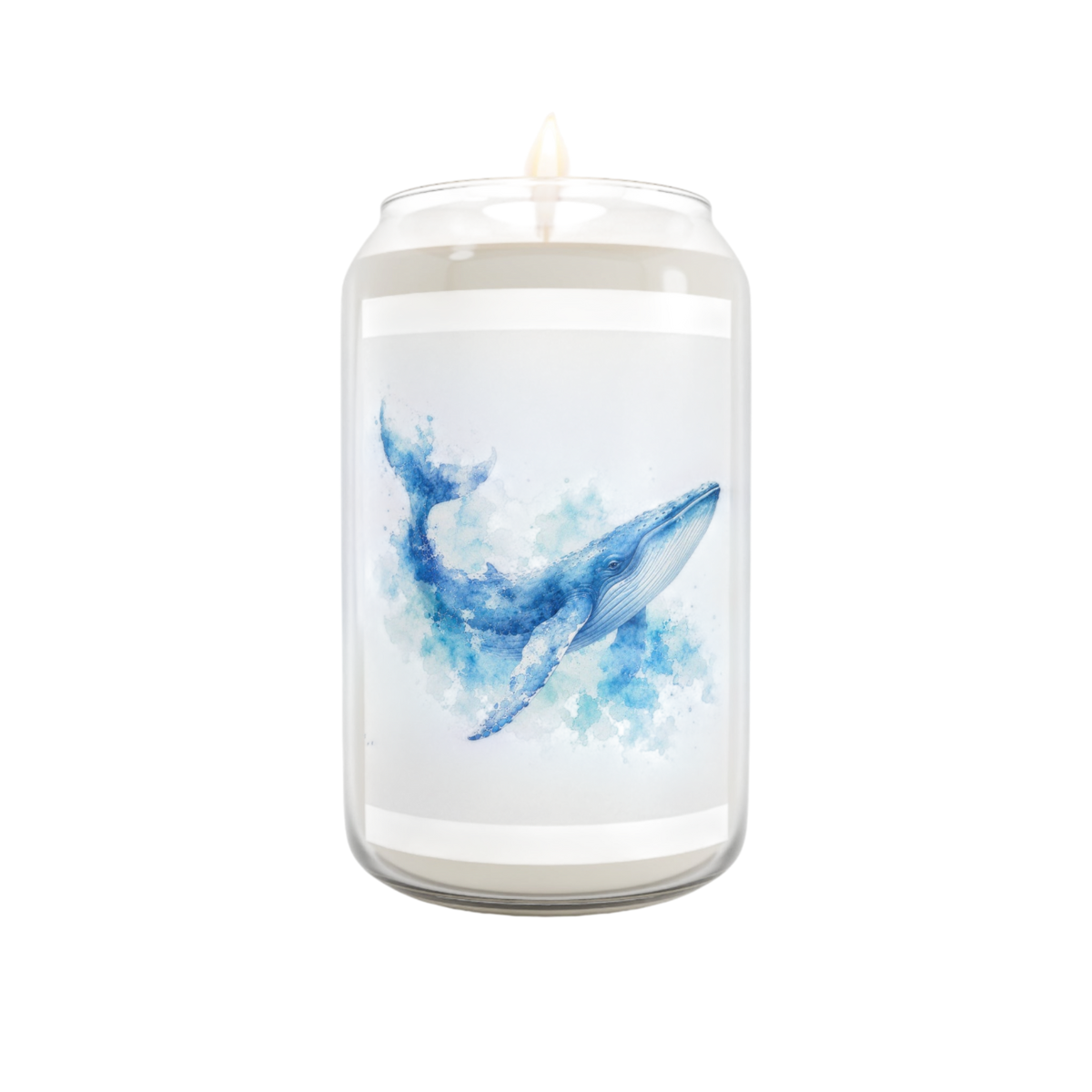 A white jar candle with a lit wick, featuring a watercolor-style blue whale illustration on the front label, set against a plain white background.