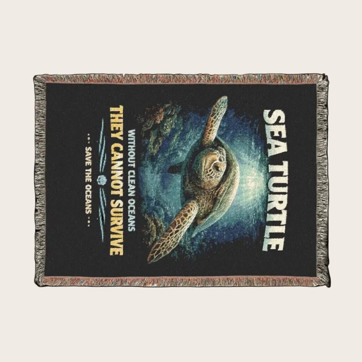 Woven blanket with a sea turtle design and environmental message on a black background