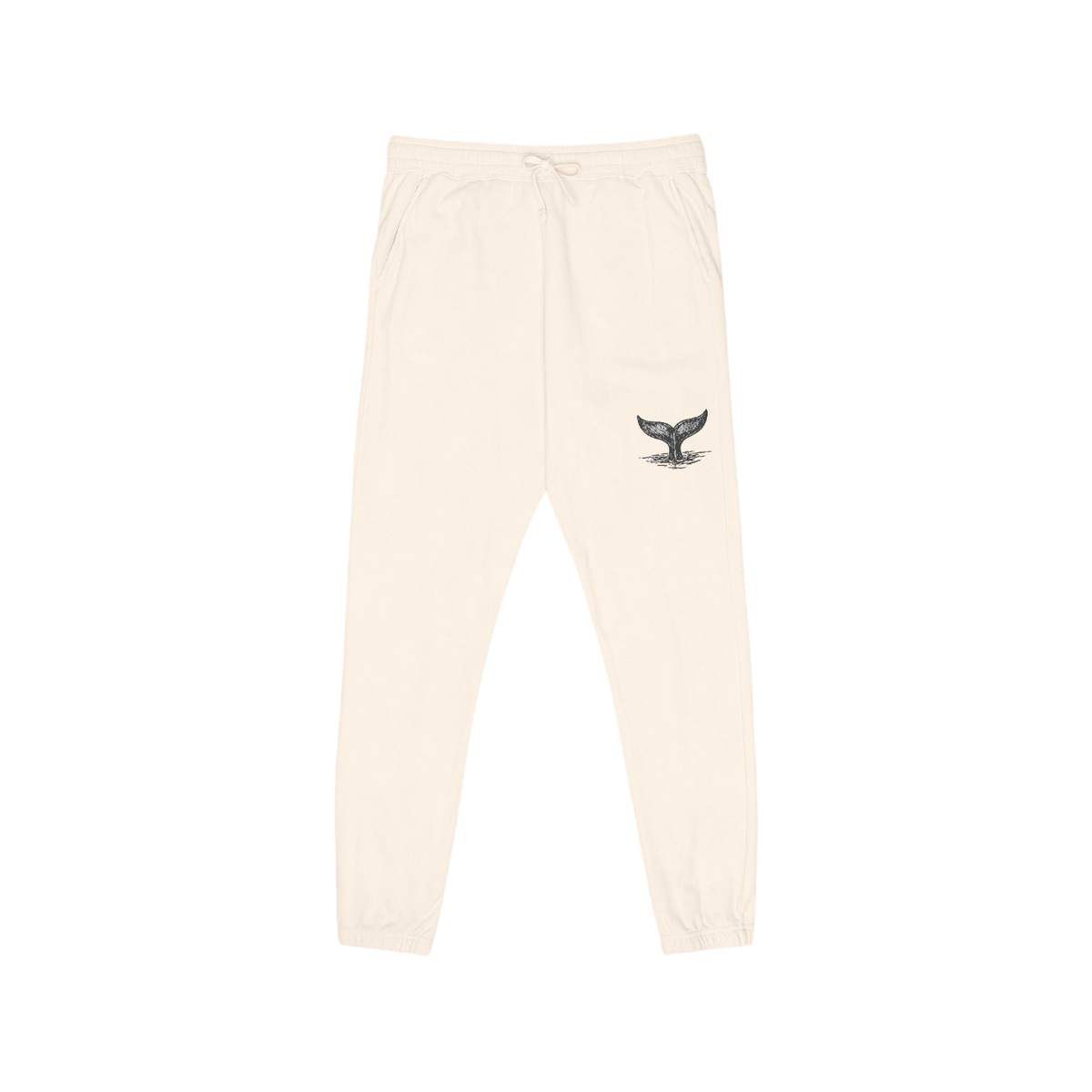 Cream-colored sweatpants with a small black whale tail graphic on the left thigh, featuring an elastic waistband with a drawstring and elastic cuffs.