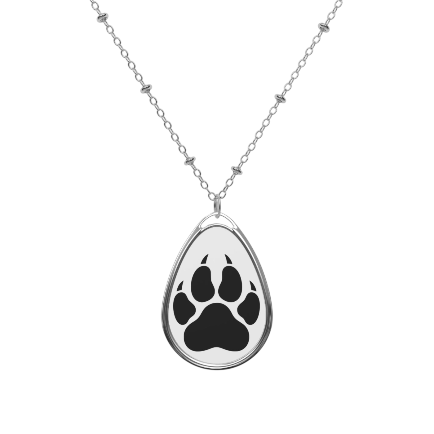 A silver teardrop pendant necklace featuring a black paw print design on a white background, suspended from a delicate silver chain with small decorative beads.