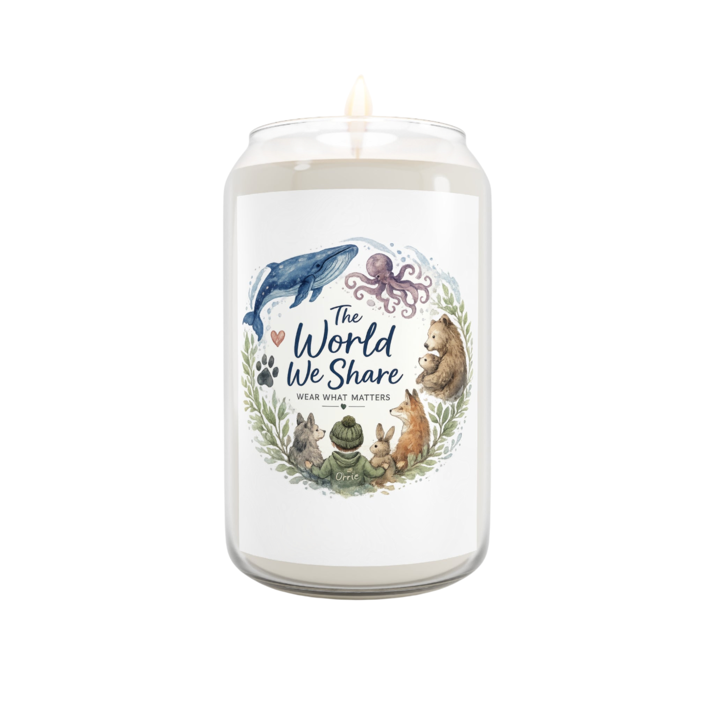 A white wax candle in a clear glass jar with a lit wick, featuring a front label that reads 'The World We Share' with illustrated animals including a blue whale, octopus, bear, rabbit, frog, and cat in a wreath design.