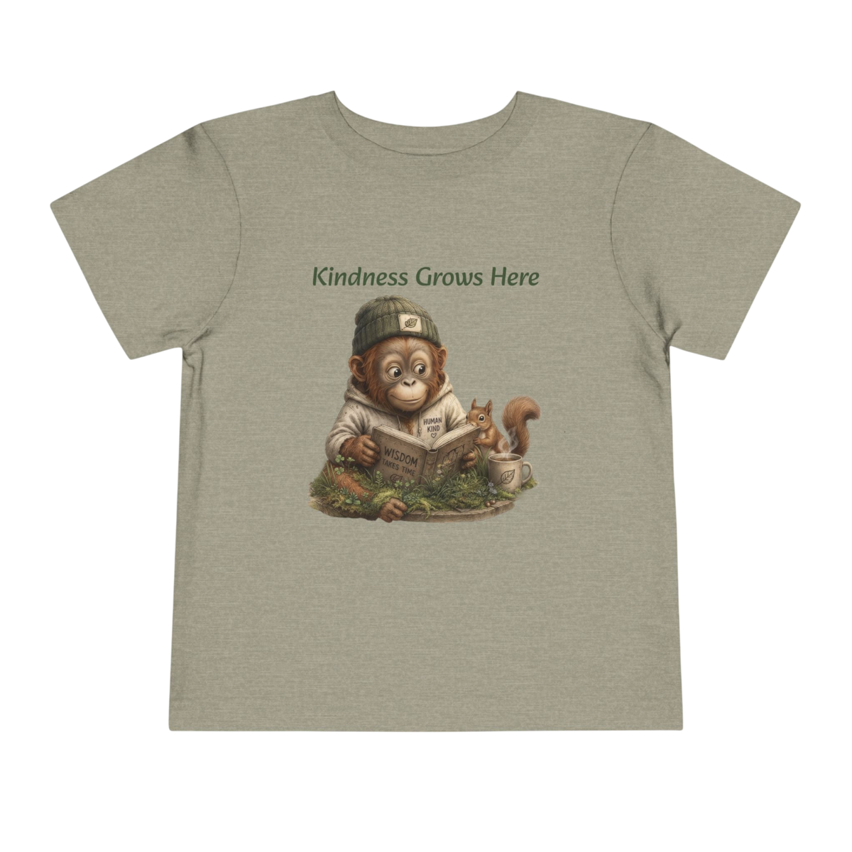 A heathered sage green short-sleeve t-shirt with a graphic of a monkey reading a book and a squirrel, with the text 'Kindness Grows Here' above the illustration, shown on a plain white background.